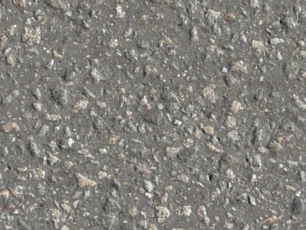 Road texture of asphalt in dark grey tone with small stones embedded consistently in surface.
